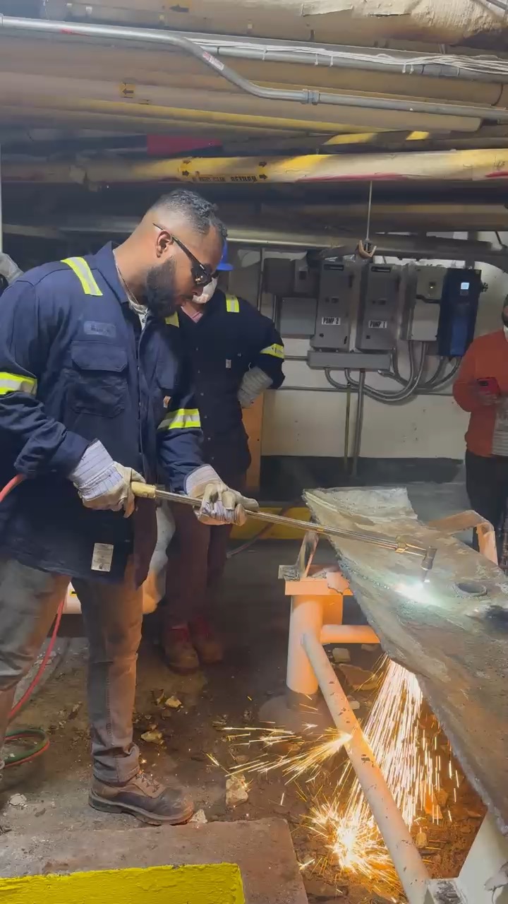 Worker cutting metal with sparks